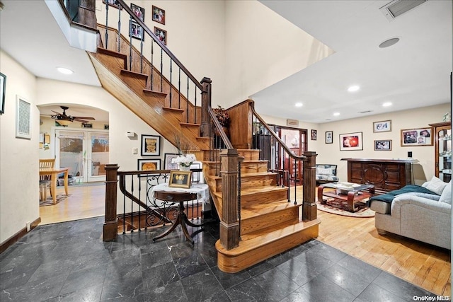 stairway featuring plenty of natural light and wood-type flooring