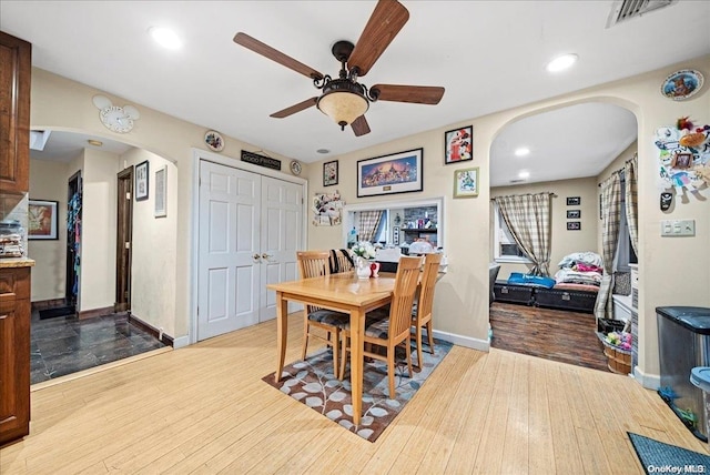 dining area featuring wood-type flooring and ceiling fan