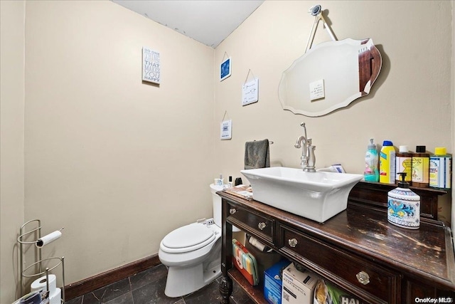 bathroom with tile patterned flooring, vanity, and toilet