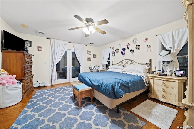 bedroom with french doors, a baseboard heating unit, hardwood / wood-style flooring, ceiling fan, and access to exterior