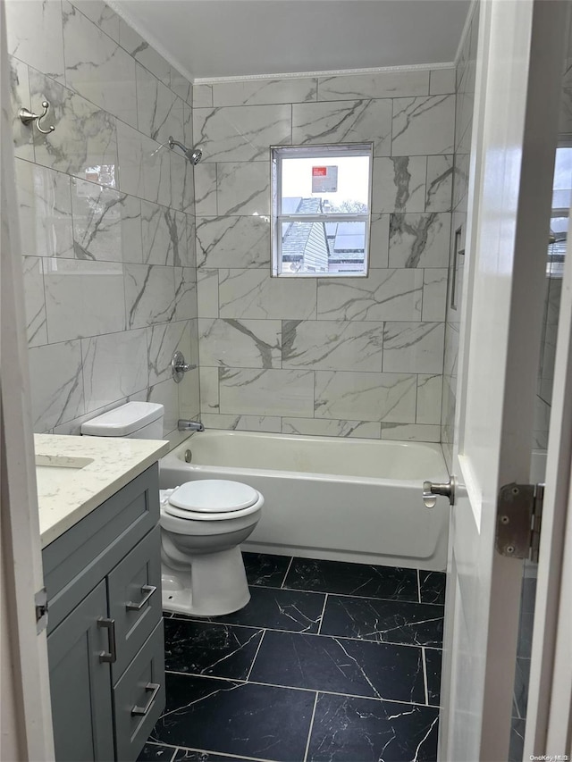 full bathroom with vanity, tiled shower / bath, and toilet