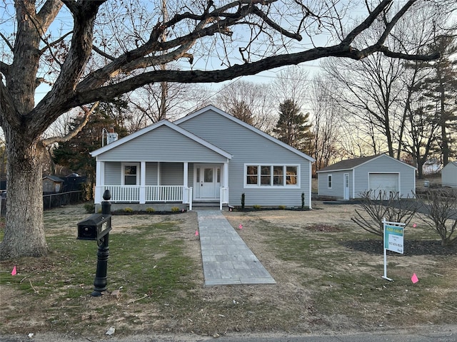 view of front facade with a garage, an outdoor structure, and a porch