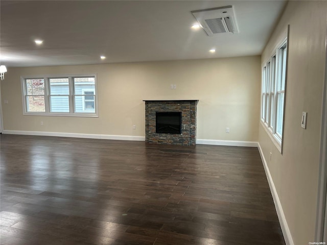 unfurnished living room with dark hardwood / wood-style floors and a fireplace