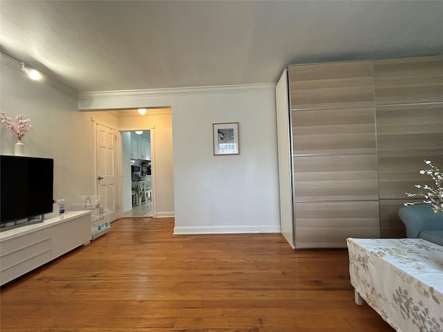 13 W Mill Dr Unit 3A, Great Neck, NY 11021 - bedroom with wood finished floors, ornamental molding, baseboards, and a closet