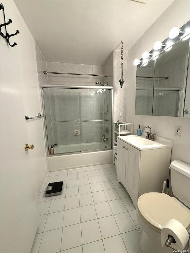 full bathroom with tile patterned flooring, vanity, toilet, and enclosed tub / shower combo