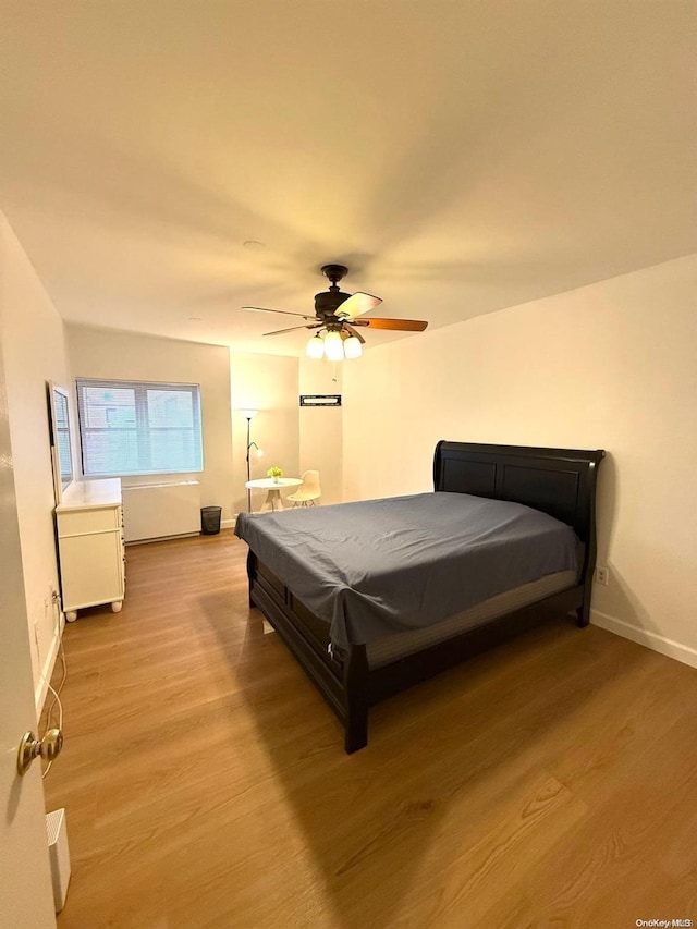 bedroom featuring light hardwood / wood-style floors, ceiling fan, and pool table