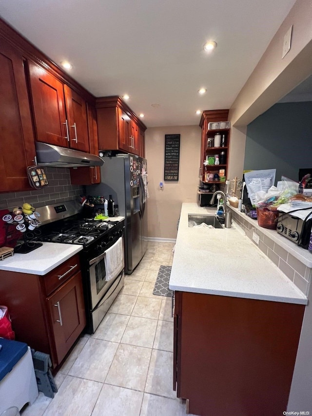 kitchen featuring sink, backsplash, kitchen peninsula, light tile patterned floors, and stainless steel range with gas stovetop