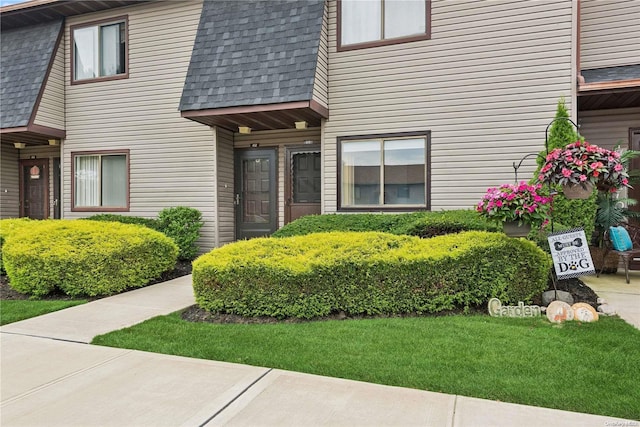 doorway to property featuring a lawn