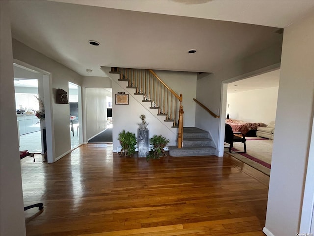 stairs featuring hardwood / wood-style floors