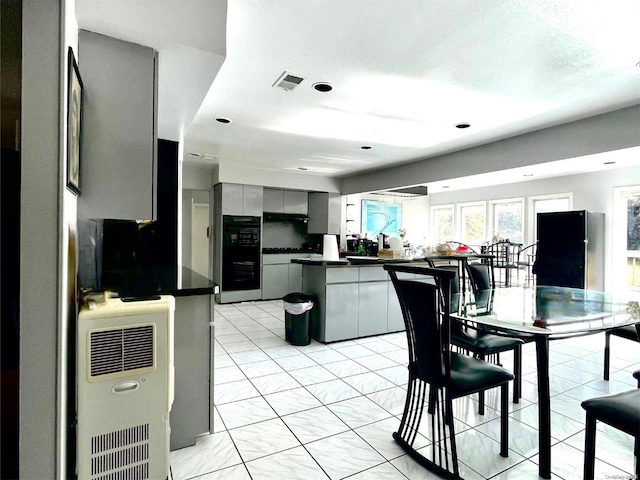 kitchen with kitchen peninsula and black refrigerator