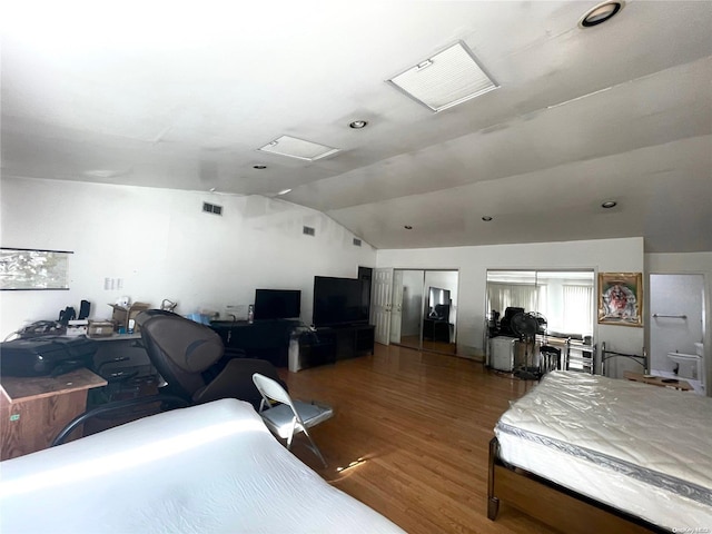 bedroom featuring vaulted ceiling and hardwood / wood-style flooring