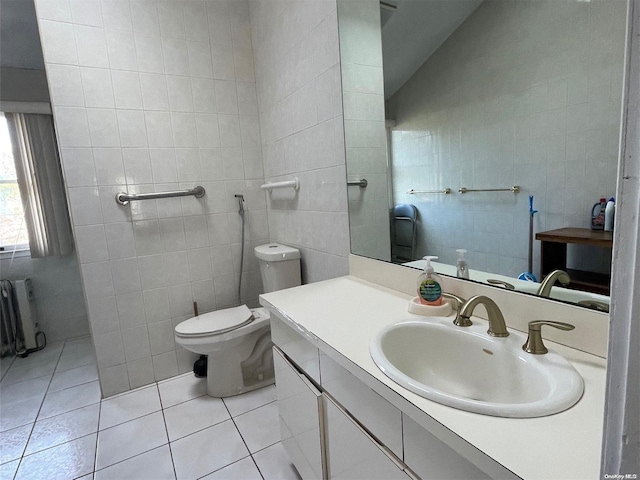 bathroom with tile patterned floors, radiator, tile walls, toilet, and lofted ceiling