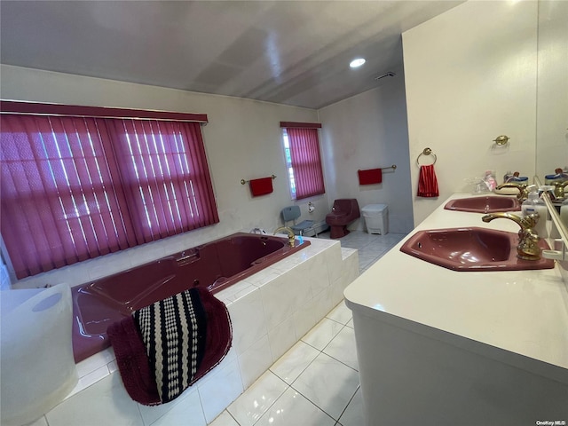 bathroom with tile patterned flooring, vanity, vaulted ceiling, and tiled tub