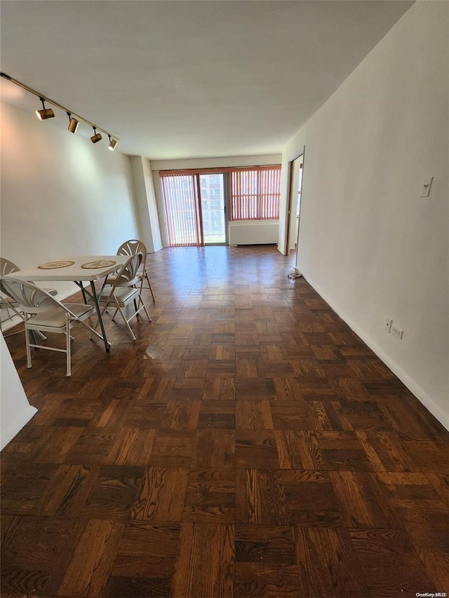 corridor with dark parquet flooring and track lighting