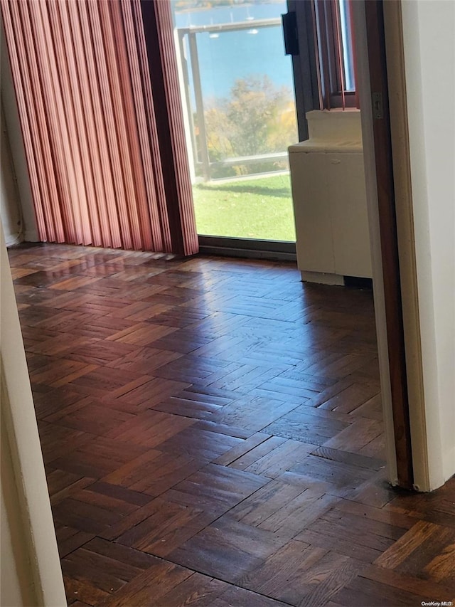 empty room with dark parquet flooring