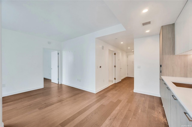 unfurnished living room featuring light wood-type flooring