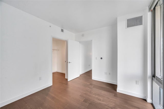 unfurnished room featuring dark hardwood / wood-style flooring