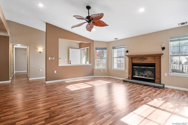 unfurnished living room with ceiling fan, wood-type flooring, and lofted ceiling