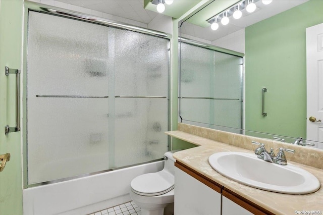 full bathroom with toilet, vanity, tile patterned floors, and enclosed tub / shower combo