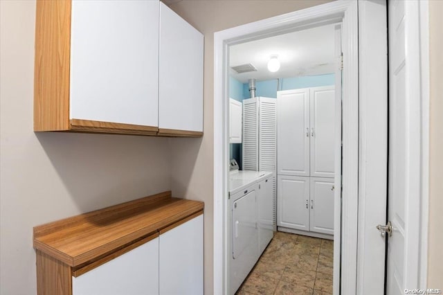 laundry area featuring cabinets and separate washer and dryer