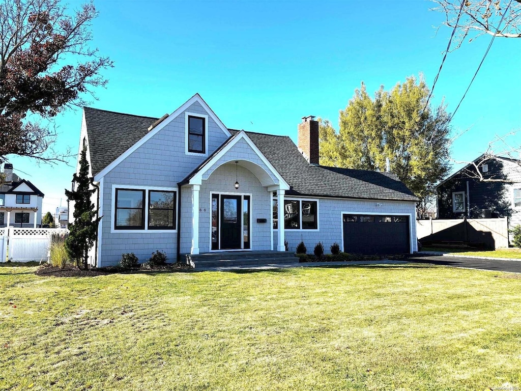 view of front of property featuring a front yard and a garage