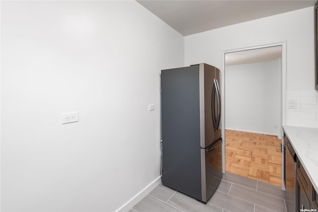 kitchen with stainless steel appliances and light parquet floors