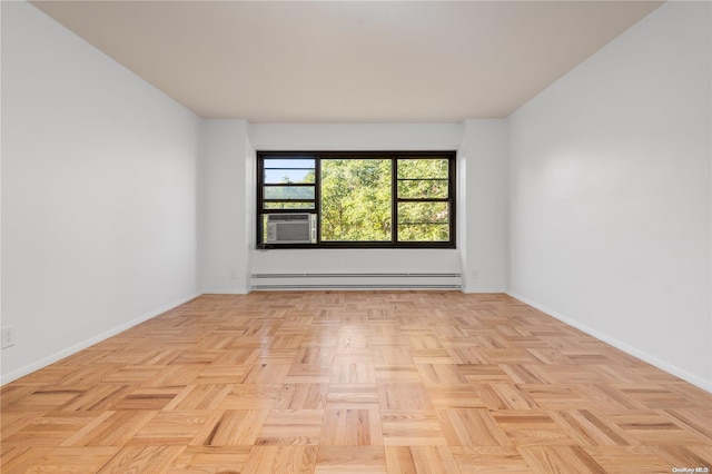 unfurnished room with light parquet flooring, a baseboard radiator, and cooling unit