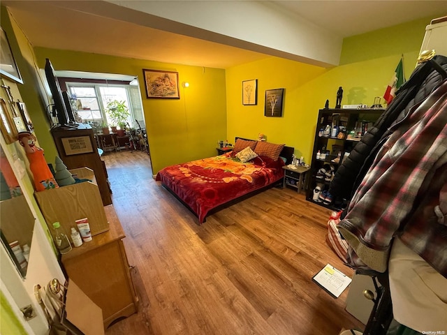 bedroom with wood-type flooring