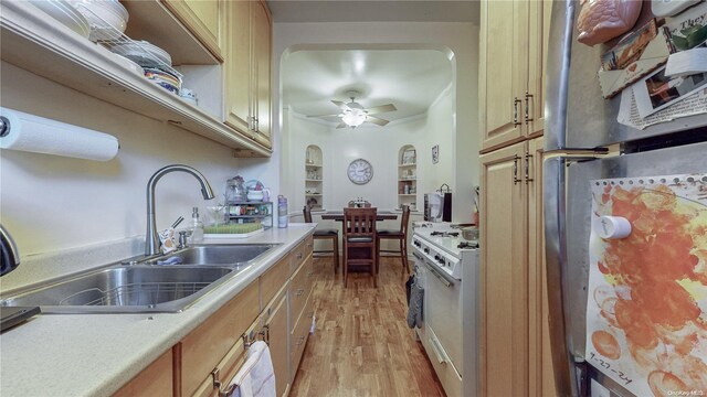 84-51 Beverly Rd Unit 4P, Kew Gardens, NY 11415 - kitchen with freestanding refrigerator, gas range gas stove, a sink, light wood-style floors, and light countertops