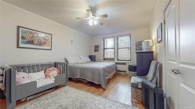 84-51 Beverly Rd Unit 4P, Kew Gardens, NY 11415 - bedroom with radiator, wood finished floors, ornamental molding, and a ceiling fan