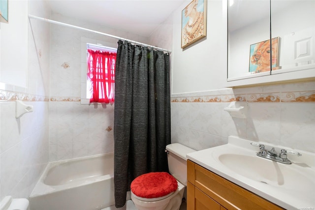 full bathroom with vanity, toilet, shower / bath combo with shower curtain, and tile walls