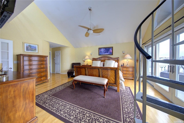 bedroom with ceiling fan, high vaulted ceiling, and light hardwood / wood-style flooring