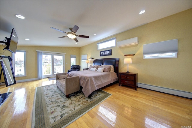 bedroom featuring ceiling fan, an AC wall unit, baseboard heating, and light hardwood / wood-style flooring