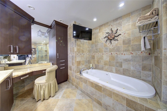 bathroom with tile patterned floors, vanity, separate shower and tub, and tile walls