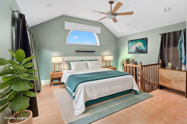 bedroom featuring ceiling fan, lofted ceiling, and light hardwood / wood-style flooring