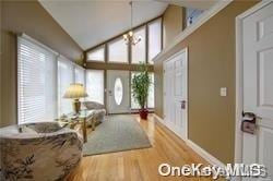 interior space with vaulted ceiling and light hardwood / wood-style floors