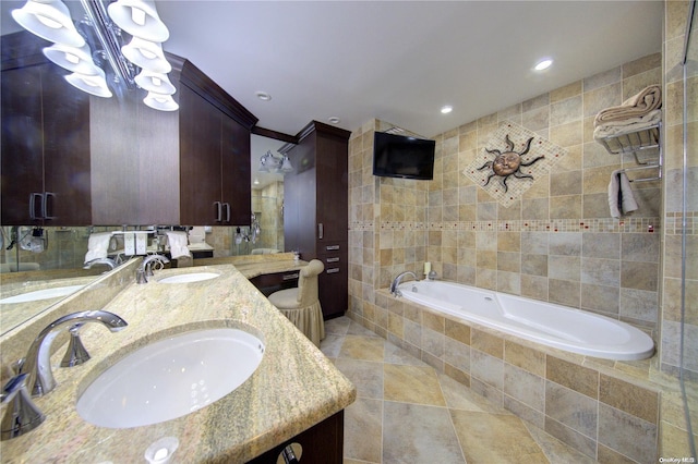 bathroom with vanity, tile patterned floors, shower with separate bathtub, and tile walls