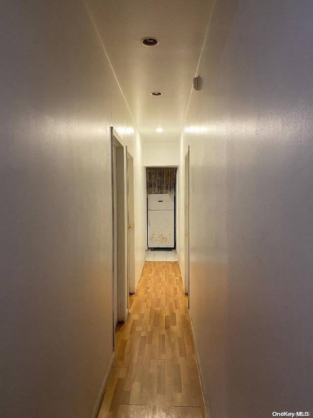 corridor featuring light hardwood / wood-style flooring