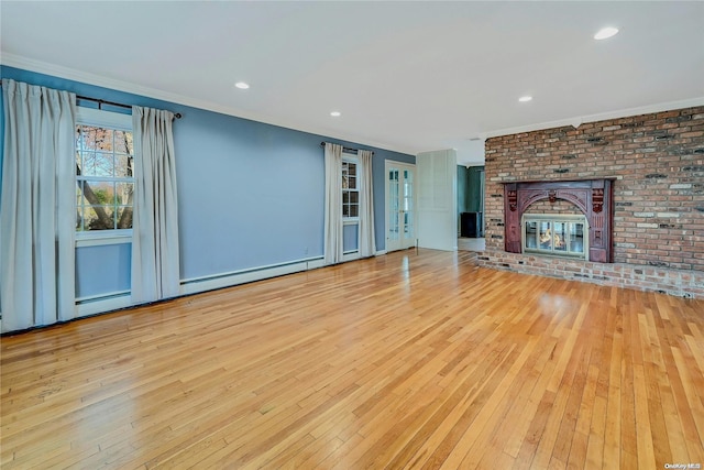 unfurnished living room with a fireplace, light hardwood / wood-style flooring, and ornamental molding