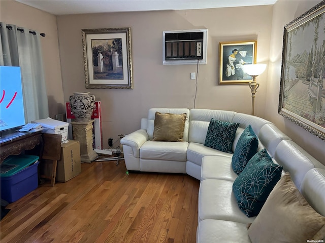 living room with a wall unit AC and wood-type flooring