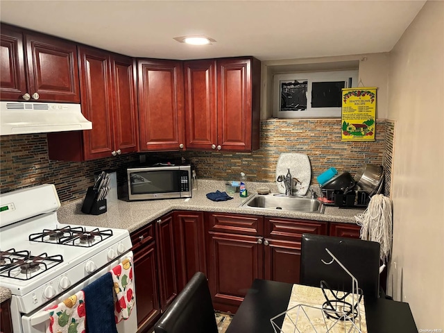 kitchen with tasteful backsplash, gas range gas stove, and sink