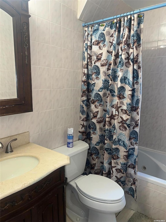 full bathroom featuring tile patterned floors, tile walls, toilet, vanity, and shower / tub combo