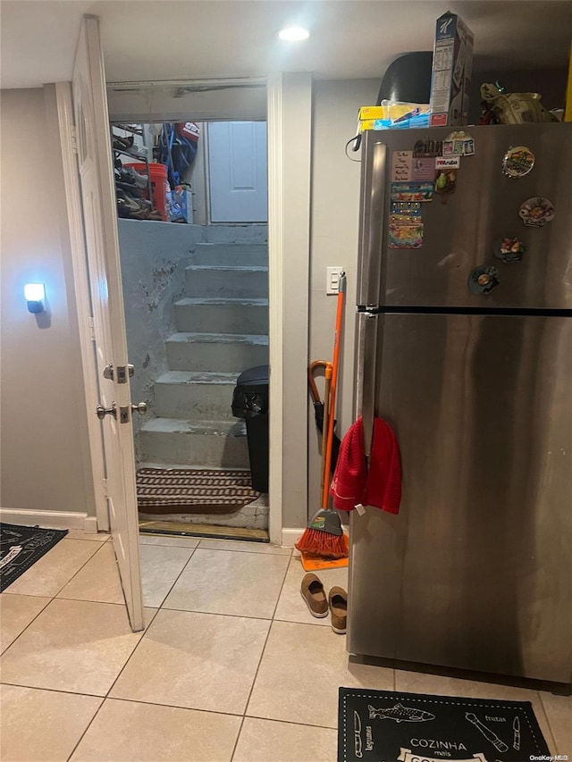 interior space featuring stainless steel refrigerator and light tile patterned floors