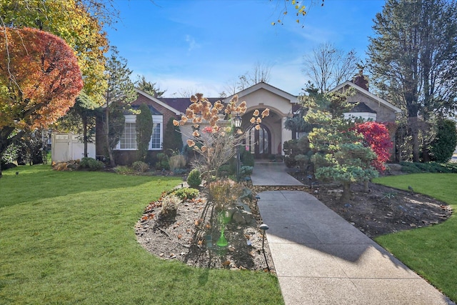 obstructed view of property with a front yard