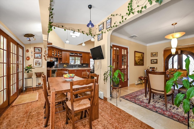 dining area featuring arched walkways, french doors, visible vents, and a baseboard radiator