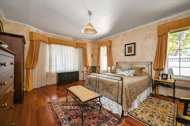 bedroom featuring multiple windows, crown molding, and hardwood / wood-style floors