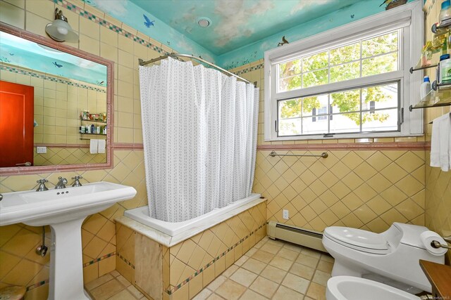 bathroom featuring tile walls, a baseboard radiator, toilet, a bidet, and tile patterned flooring