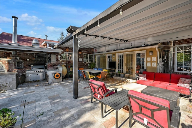 view of patio with area for grilling, outdoor dining area, and outdoor lounge area