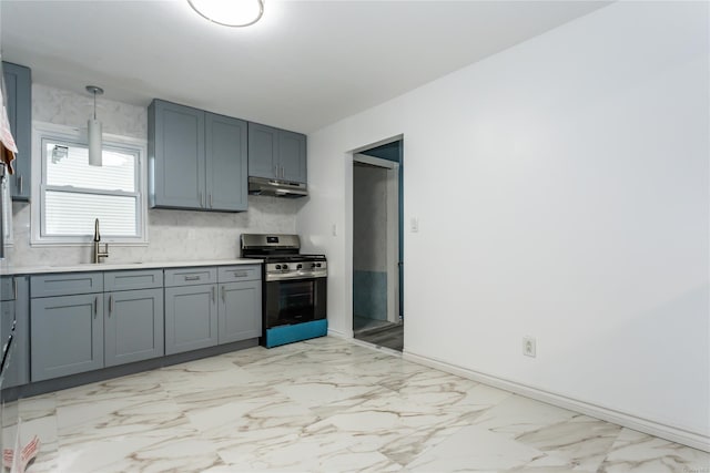 kitchen featuring gas range, sink, gray cabinets, and pendant lighting