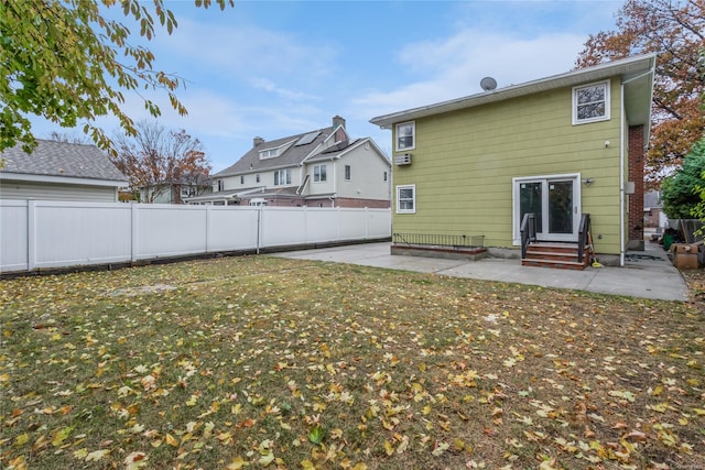 back of property featuring a patio area and a yard